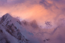 Fast Moving Weather Over The Annapurna Range At Sunset. Clouds Move Through The Sunset Over Snowy Himalayan Mountains.