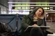 Woman transit traveller sleeping at the airport, waiting for a flight