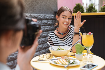 Wall Mural - Engaged woman. Beaming engaged woman feeling extremely happy while showing it her friend in cafeteria