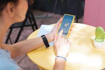 checking forecast. modern remote worker checking weather forecast on her phone while planning picnic