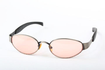 Canvas Print - Old scratched sunglasses with metal frame and pink glass on a white background