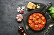 © lilechka75 - Spicy meatballs in tomato sauce in a cast iron pan.Top view with copy space.