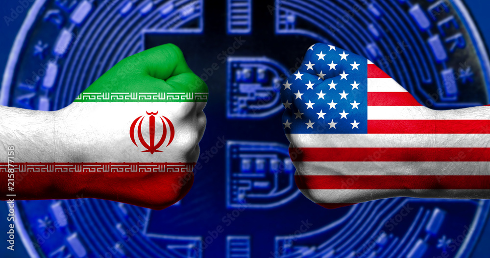 Flags of USA and Iran painted on two clenched fists facing each other with bitcoin in the background/ Iran USA conflict concept