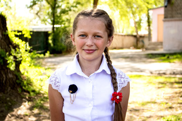 Portrait of a teenage girl, in strict clothing.  The girl in the park