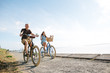 © Rob and Julia Campbell/Stocksy - Healthy, active couple enjoying life riding cruiser bikes near o