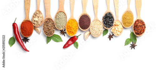 Fotografía Composition with different aromatic spices in wooden spoons on white background