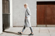 © Lyuba Burakova/Stocksy - Young woman walking down the street