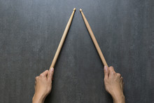 Hand Holding Drum Stick On Black Table Background, Music Practice Concept