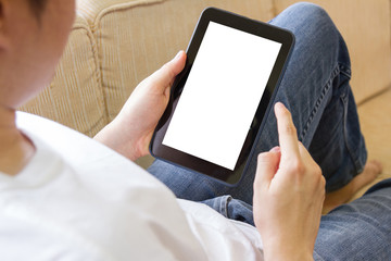 man using tablet computer in living room