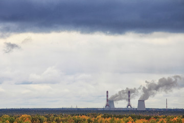 The fogging of the atmosphere by a thermal power plant on an autumn day.