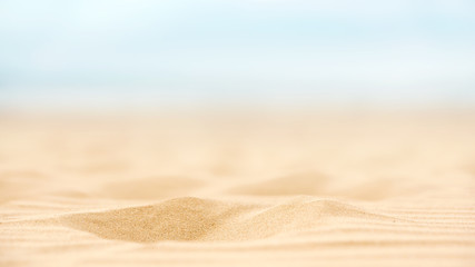 Wall Mural - Close up sand beach with blurred sea sky background, summer day, copy space.