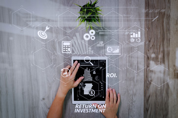 Aufkleber - businessman hand working with digital tablet computer. Digital business strategy layer effect. On wood desk with plant. View from top. Double exposure effects, Minimalism