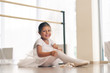 © Kitreel - Portrait of a beautiful very young girl, in a dance school wearing a white tutu, she trains alone to learn new dance steps. Concept of: ambition, education, elegance and love for the dance...