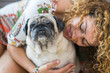 © simona - true love between beautiful caucasian woman and old dog pug, Odd friends and family alternative concept. cheerful lady and smile domestic animal. portraits