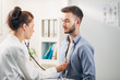 © Suteren Studio - Doctor Examining Patient in Office