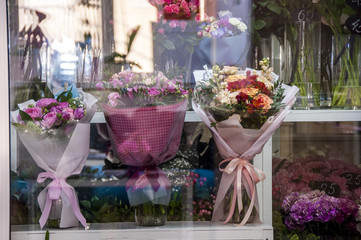 showcase of the floristic store, 3 elegant bouquets in anticipation of the buyer. Small business. Floral design studio, making decorations and arrangements