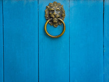 Lion Head Door Knocker On Blue Wooden Door.