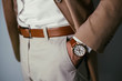 Vintage smart casual outfit outdoor.Fashion model man posing in office.Suited man posing.closeup fashion image of luxury watch on wrist of man.body detail of a business man.Not isolated.