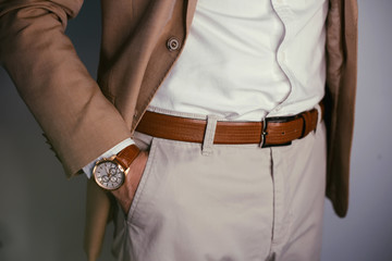 closeup fashion image of luxury watch on wrist of man.body detail of a business man.man's hand in br