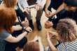 © Photographee.eu - Close-up of hands of teenagers sitting in a circle during a support meeting