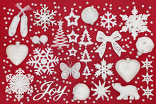 Christmas Joy Sign With Sparkling White And Silver Bauble Decorations On Red Background. Traditional Christmas Greeting Card For The Festive Season. 