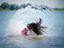 Girl Splashing River Water By Her Hair
