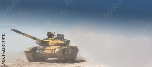 Tela Military or army tank ready to attack and moving over a deserted battle field terrain