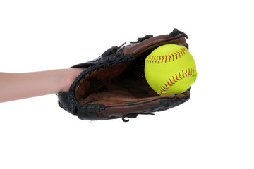 girl catching softball in glove isolated white background