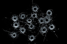 Broken Glass Multiple Bullet Holes In Glass Isolated On Black