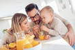 © ivanko80 - Cheerful young family making orange juice