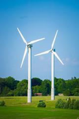 windmill type wind electricity generator in the field in latvia in summer