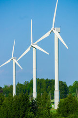 Wall Mural - windmill type wind electricity generator in the field in latvia in summer
