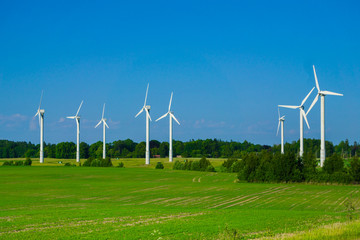 Wall Mural - windmill type wind electricity generator in the field in latvia in summer