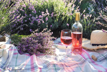 Bottle And Glass Of Wine On Blanket In Lavender Field