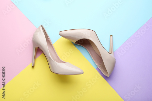 Beige high heel shoes on colorful background Poster Mural XXL