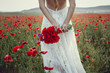 beauty woman in poppy field in white dress