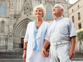 Wall Mural - Close up of romantic senior couple on city streets on joint vacation