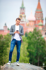 Happy young urban man drinking coffee in european city.