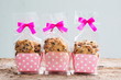 Chocolate chip cookies in plastic bag packaging with ribbon bow.