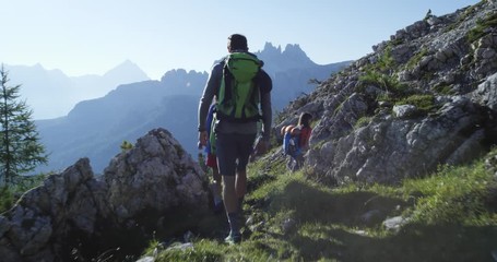 four friends walking along hiking trail path. group of friends people summer adventure journey in mo