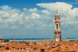 Venice historic center skyline over Cannareggio District with old bell tower, lagoon and clouds (with copy space)