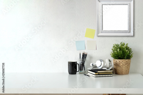 Fotografía Stylish workspace with mockup poster and gadget