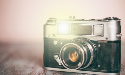 Old camera on wooden desk