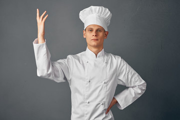 cook in uniform on gray background