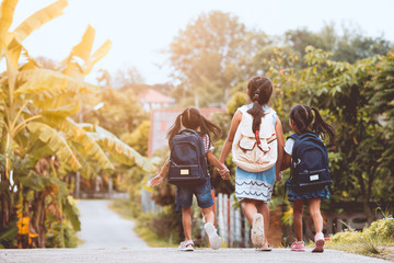 Wall Mural - Back to school. Asian  pupil kids with backpack going to school together in vintage color tone