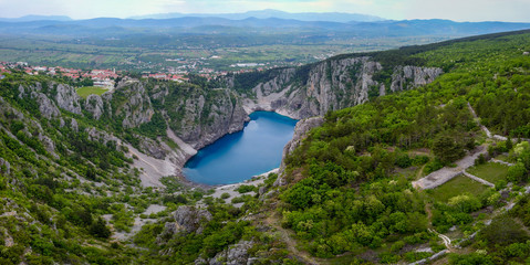 Wall Mural - Blue Lake (Croatian: Modro jezero or Plavo jezero) is a karst lake located near Imotski in Croatia. It lies in a deep sinkhole possibly formed by the collapse of an enormous cave.