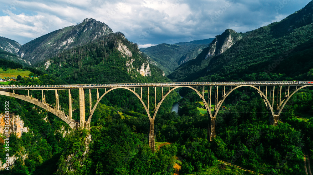 Aerial View of Durdevica Tara Arc Bridge in the Mountains, One of the Highest Automobile Bridges in Europe. - obrazy, fototapety, plakaty 