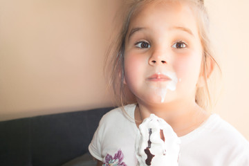 A little girl eating a creamy ice cream