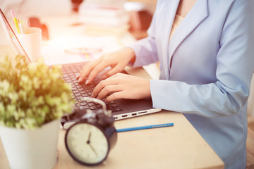 Businesswoman typing on laptop at workplace. Working concept.