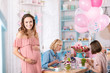 © zinkevych - Open shoulder dress. Stylish pregnant woman wearing nice pink open shoulder dress feeling very memorable
